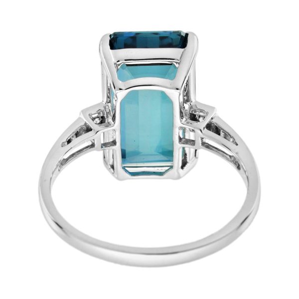 8.80ct Emerald Cut Blue Topaz Solitaire Engagement Ring, single stone deep greenish-blue London topaz with sparkling diamond to each side in 18ct white gold