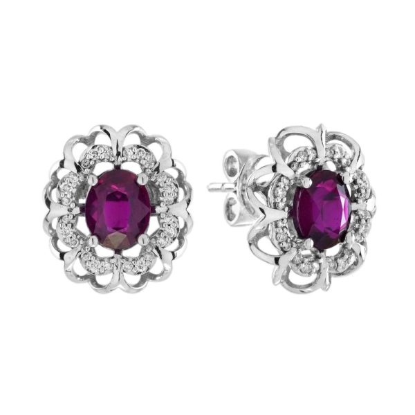 2ct Ruby and Diamond Flower Cluster Stud Earrings, oval red rubies within diamond halo surround and outer gold floral design border in 14ct white gold