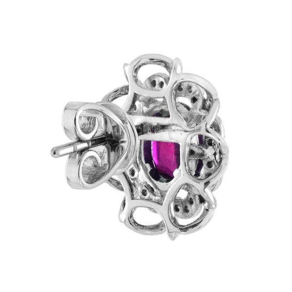 2ct Ruby and Diamond Flower Cluster Stud Earrings, oval red rubies within diamond halo surround and outer gold floral design border in 14ct white gold