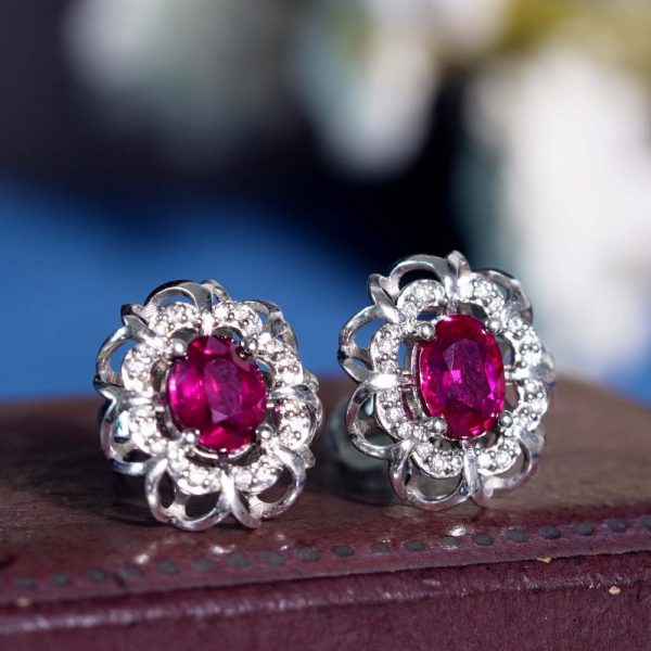 2ct Ruby and Diamond Flower Cluster Stud Earrings, oval red rubies within diamond halo surround and outer gold floral design border in 14ct white gold