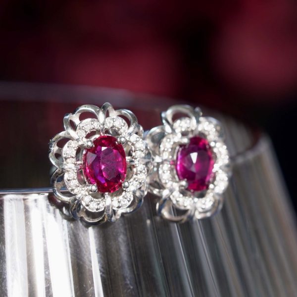 2ct Ruby and Diamond Flower Cluster Stud Earrings, oval red rubies within diamond halo surround and outer gold floral design border in 14ct white gold