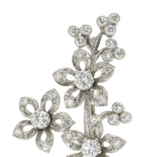 Platinum and diamond flower branch brooch.