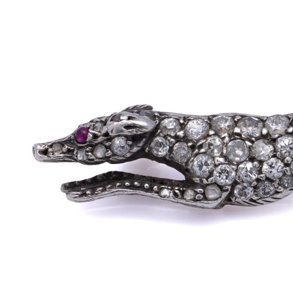 Antique gold and silver greyhound brooch with diamonds and ruby.