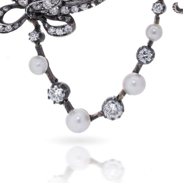 Edwardian diamond and pearl brooch in gold and silver.