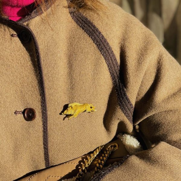 Gold running wild boar brooch.