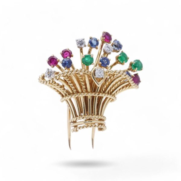 Cartier vintage flower basket brooch with gemstones in gold.