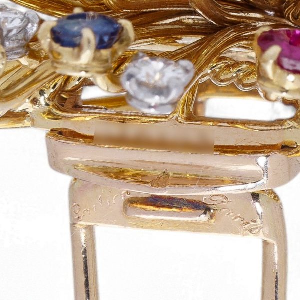 Cartier vintage flower basket brooch with gemstones in gold.