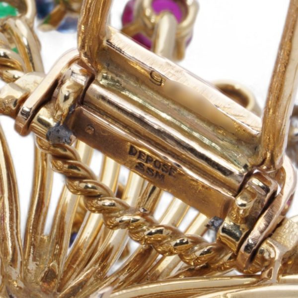 Cartier vintage flower basket brooch with gemstones in gold.