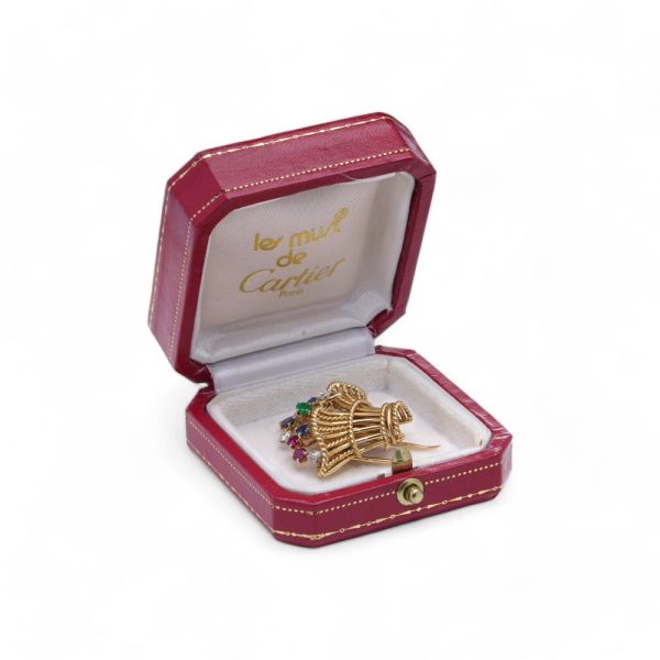 Cartier vintage flower basket brooch with gemstones in gold.