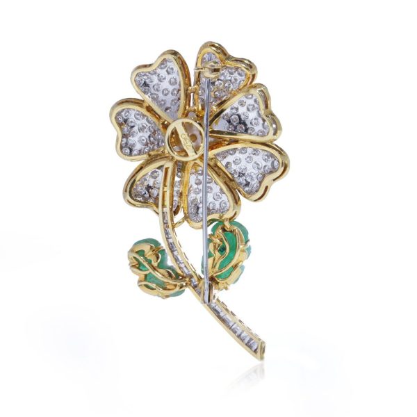 Floral brooch with pearl, diamonds and emeralds in gold.