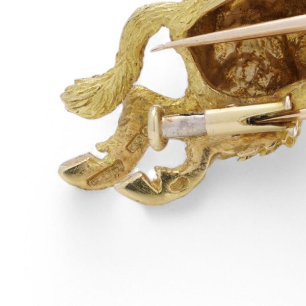 Gold running wild boar brooch.