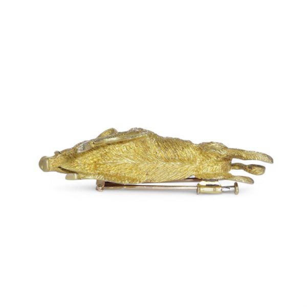 Gold running wild boar brooch.