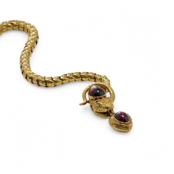 Victorian snake necklace with garnets and emeralds in gold.