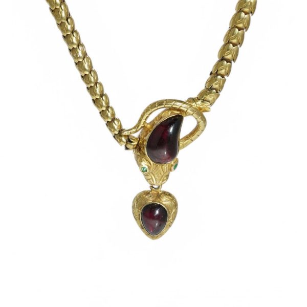 Victorian snake necklace with garnets and emeralds in gold.
