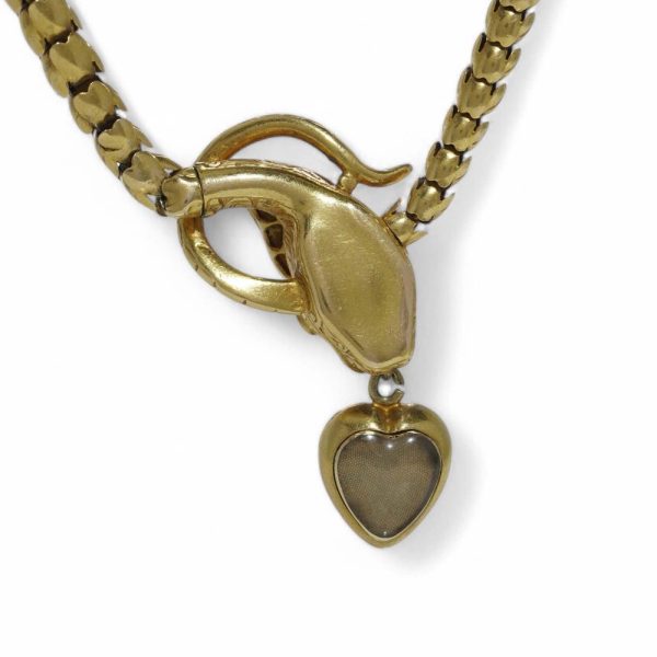 Victorian snake necklace with garnets and emeralds in gold.