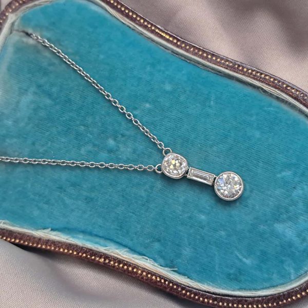 Antique Art Deco 1.35ct Old Cut Diamond Pendant Necklace in Platinum, 0.50ct old mine-cut, 0.15ct baguette-cut and 0.70ct old European transitional diamond
