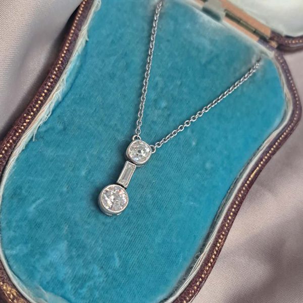 Antique Art Deco 1.35ct Old Cut Diamond Pendant Necklace in Platinum, 0.50ct old mine-cut, 0.15ct baguette-cut and 0.70ct old European transitional diamond