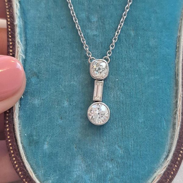 Antique Art Deco 1.35ct Old Cut Diamond Pendant Necklace in Platinum, 0.50ct old mine-cut, 0.15ct baguette-cut and 0.70ct old European transitional diamond