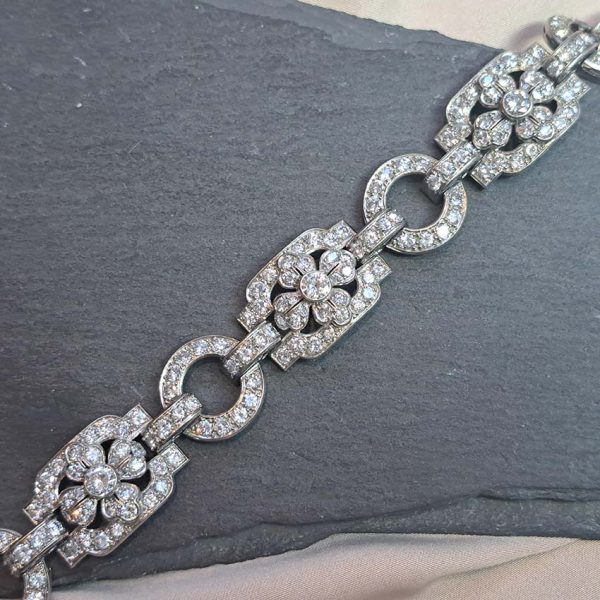 Art Deco French Diamond Bracelet in Platinum, floral motifs within geometric design, set with 20.80 carats of old brilliant-cut diamonds. Circa 1925