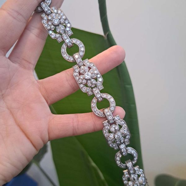 Art Deco French Diamond Bracelet in Platinum, floral motifs within geometric design, set with 20.80 carats of old brilliant-cut diamonds. Circa 1925