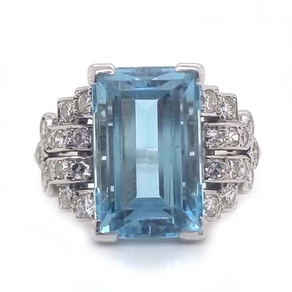 Art Deco 5.5ct Aquamarine and Diamond Dress Ring, rectangular step-cut aquamarine flanked by stepped geometric diamond shoulders in platinum. Circa 1920s
