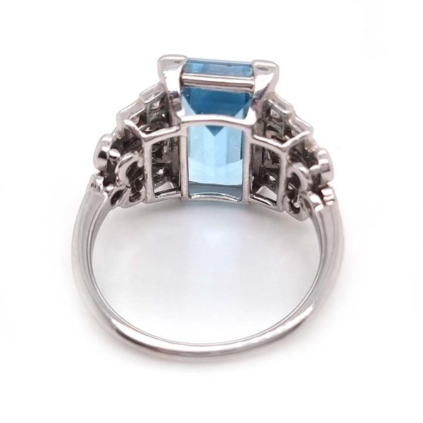 Art Deco 5.5ct Aquamarine and Diamond Dress Ring, rectangular step-cut aquamarine flanked by stepped geometric diamond shoulders in platinum. Circa 1920s