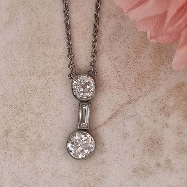 Antique Art Deco 1.35ct Old Cut Diamond Pendant Necklace in Platinum, 0.50ct old mine-cut, 0.15ct baguette-cut and 0.70ct old European transitional diamond