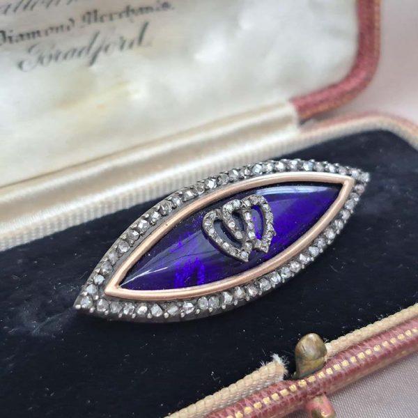 Victorian Antique Blue Enamel and Diamond Navette Brooch, navette-shaped brooch decorated with blue enamel with two diamond entwinned hearts within diamond border