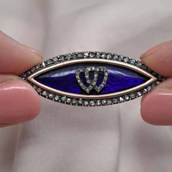 Victorian Antique Blue Enamel and Diamond Navette Brooch, navette-shaped brooch decorated with blue enamel with two diamond entwinned hearts within diamond border