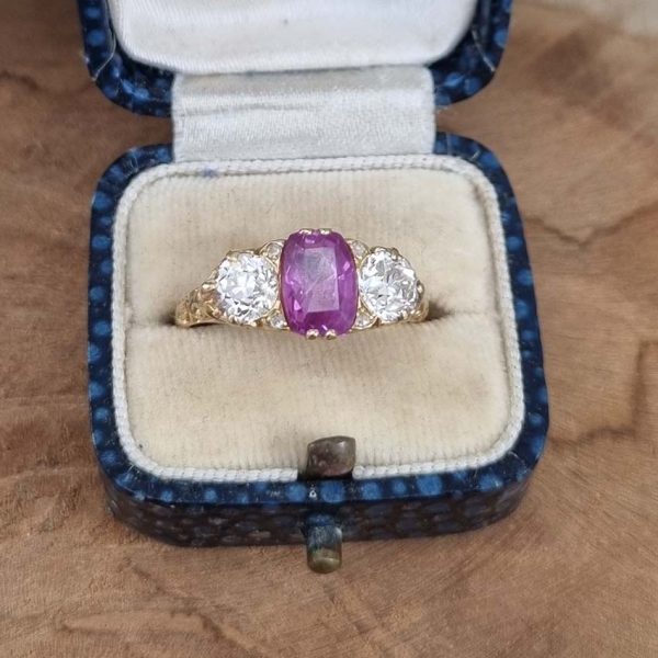 Antique 2ct Natural Pink Sapphire and Diamond Trilogy Three Stone Engagement Ring, 2.03ct deep purplish pink sapphire flanked by 1ct old-cut diamonds in 18ct yellow gold. Circa 1880