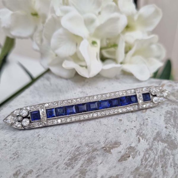 Art Deco 5.5ct Sapphire and Diamond Bar Brooch in Platinum, line of baguette rectangular square shaped step-cut sapphires within 3.50ct old European transitional cut diamonds