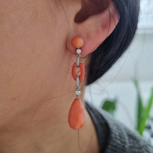 Art Deco Coral and Diamond Drop Earrings, round cabochon coral top leading to articulated diamond and coral links to pear shaped coral teardrop pendant drops in 18ct white gold. Circa 1930s