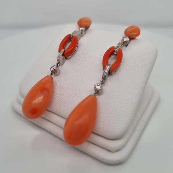 Art Deco Coral and Diamond Drop Earrings, round cabochon coral top leading to articulated diamond and coral links to pear shaped coral teardrop pendant drops in 18ct white gold. Circa 1930s