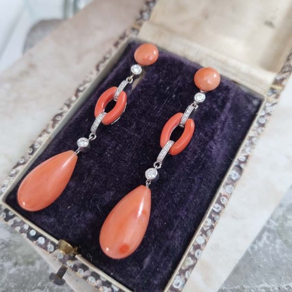 Art Deco Coral and Diamond Drop Earrings, round cabochon coral top leading to articulated diamond and coral links to pear shaped coral teardrop pendant drops in 18ct white gold. Circa 1930s