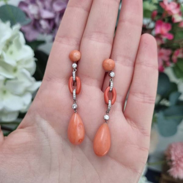 Art Deco Coral and Diamond Drop Earrings, round cabochon coral top leading to articulated diamond and coral links to pear shaped coral teardrop pendant drops in 18ct white gold. Circa 1930s