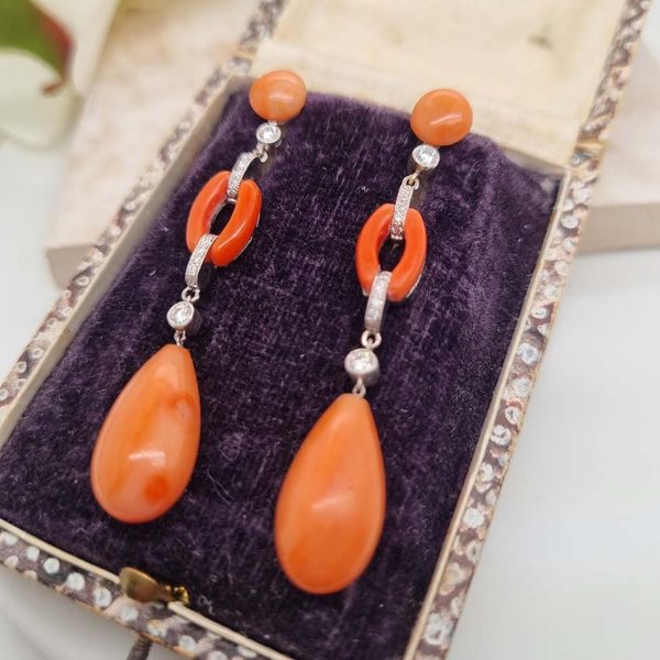 Art Deco Coral and Diamond Drop Earrings, round cabochon coral top leading to articulated diamond and coral links to pear shaped coral teardrop pendant drops in 18ct white gold. Circa 1930s