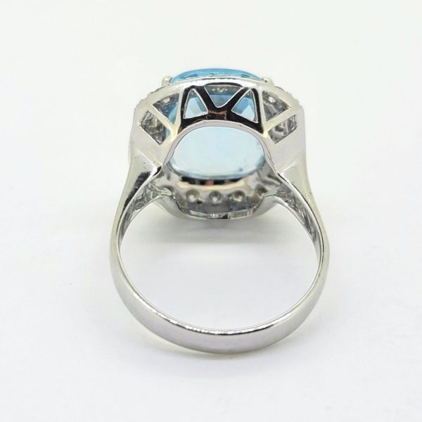 Contemporary 4.64ct Cushion Cut Aquamarine and Diamond Cluster Ring, 4.64ct cushion-shaped aquamarine surrounded by diamonds, with brilliant-cut diamonds to the top and bottom accented with baguette-cut diamonds to the sides in 18ct white gold