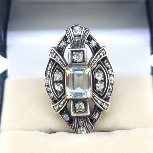 Aquamarine and Diamond Navette Cluster Ring in Silver on Gold, emerald-cut aquamarine nestled within diamond-set openwork navette-shaped surround