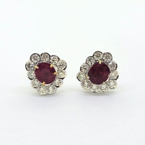 Ruby and Diamond Floral Cluster Stud Earrings, 1.74cts oval red rubies surrounded by 0.75cts sparkling round brilliant-cut diamonds in 18ct white gold