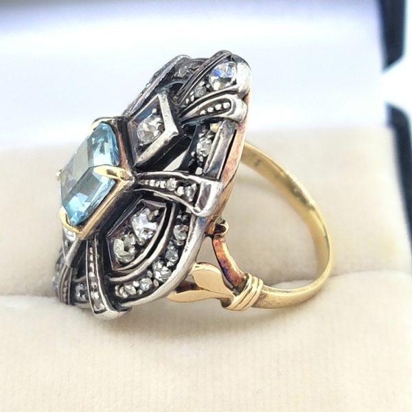 Aquamarine and Diamond Navette Cluster Ring in Silver on Gold, emerald-cut aquamarine nestled within diamond-set openwork navette-shaped surround