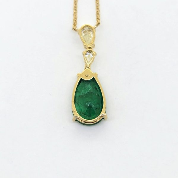 8ct Pear Cut Emerald and Diamond Drop Pendant Necklace, 8.04ct pear shaped emerald and double diamond pendant suspended on fixed chain in 18ct yellow gold