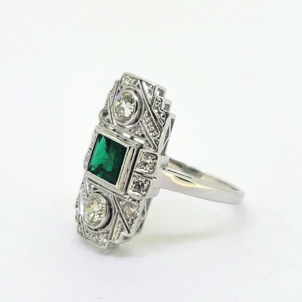 Art Deco Colombian Emerald and Diamond Tablet Plaque Ring, square step-cut Colombian emerald flanked top and bottom by sparkling diamond all within tablet surround accented with smaller diamonds in 18ct white gold
