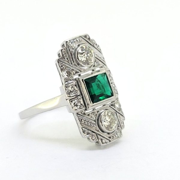 Art Deco Colombian Emerald and Diamond Tablet Plaque Ring, square step-cut Colombian emerald flanked top and bottom by sparkling diamond all within tablet surround accented with smaller diamonds in 18ct white gold