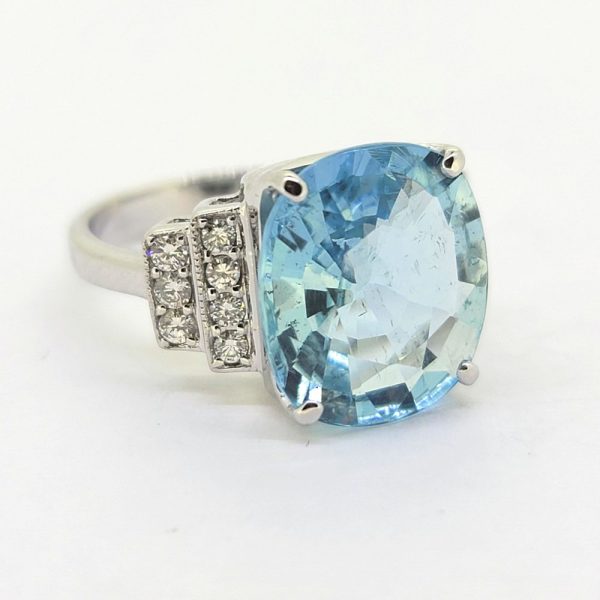 6ct Oval Aquamarine and Diamond Dress Ring, 6.04ct oval aquamarine flanked by diamond-set stepped shoulders in 18ct white gold