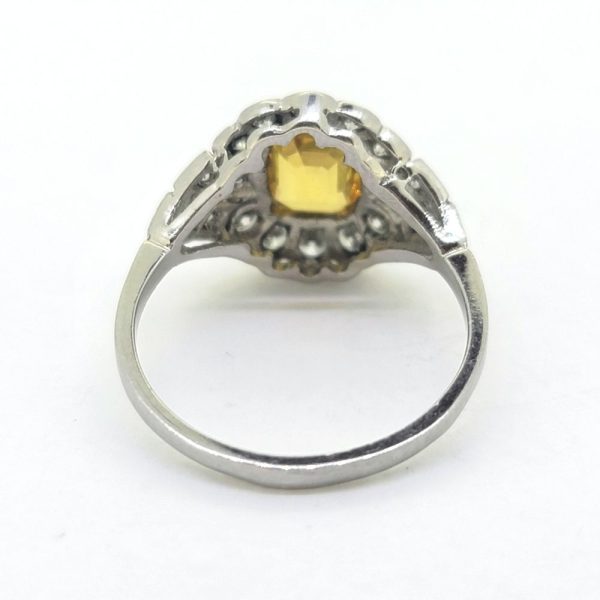 Decorative 1.40ct Yellow Sapphire and Diamond Cluster Dress Ring in Platinum, 1.40ct emerald-cut yellow sapphire sits proud within floral diamond surround which leads to tapered diamond shoulders