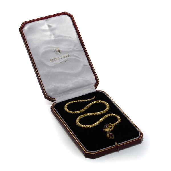 Victorian snake necklace with garnets and emeralds in gold.