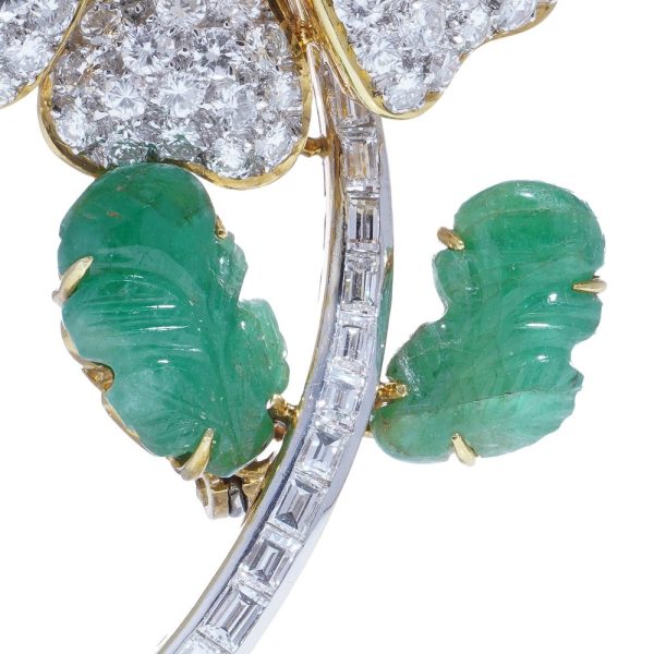 Floral brooch with pearl, diamonds and emeralds in gold.