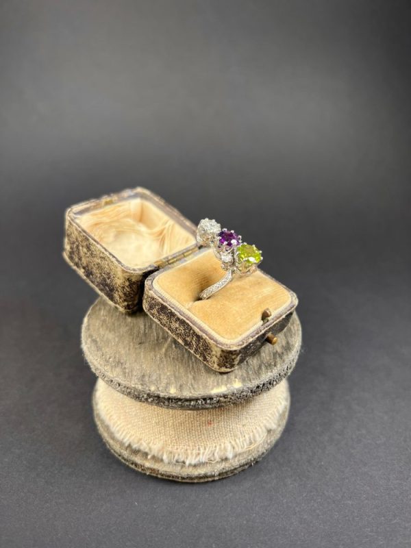 Edwardian Antique French Suffragette Amethyst Peridot Diamond Three Stone Ring, graduating trilogy of peridot amethyst and diamond arranged vertically up the finger when worn in 18ct white gold on diamond-set band with French eagles head stamp