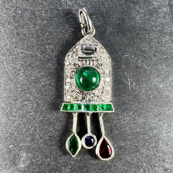 Art Deco Emerald and Diamond Pendant with Ruby Sapphire, platinum charm pendant designed as a diamond and emerald cuckoo clock with sapphire, ruby and emerald weights and pendulum