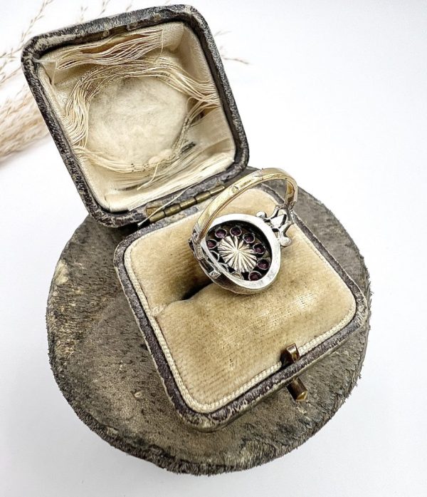 Early Victorian Antique Moonstone Ruby and Diamond Cluster Ring, oval cabochon moonstone surrounded by ruby petals within outer halo border of old-cut diamonds in silver to 18ct yellow gold. Mid 19th century Circa 1865